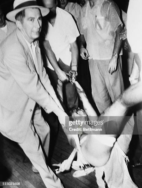 Police carry off a struggling Richard Carpenter, who was arrested for the murder of two police officers. During the arrest attempt, Carpenter holed...