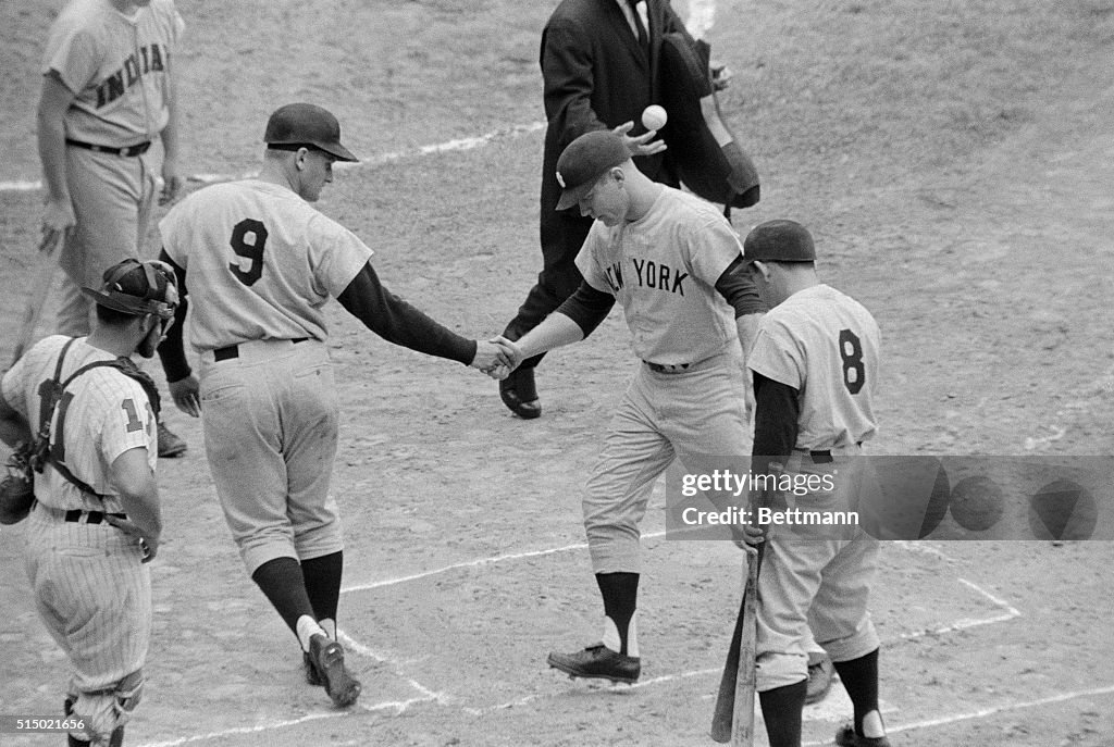 Mickey Mantle and Roger Maris Shaking Hands on Baseball Field