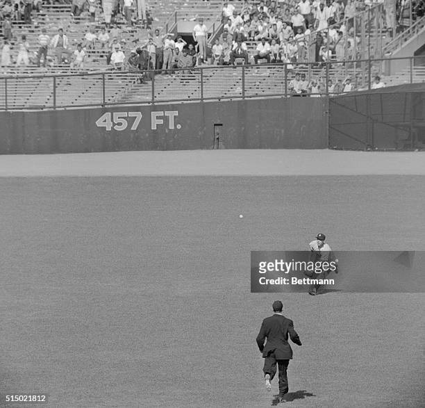 New York Yankee center fielder Mickey Mantle charges in after a looping fly ball hit by Chicago White Sox pinch hitter Camilio Carreon in the ninth...