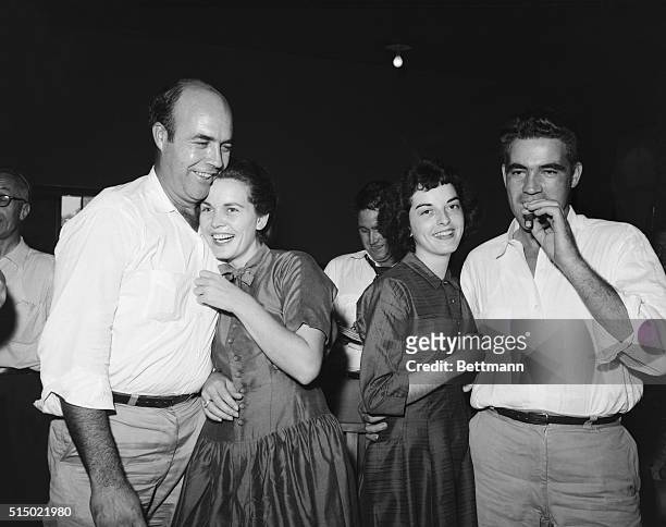 After their acquittal in the Emmett Till trial, defendant Roy Bryant , smokes a cigar as his wife happily embraces him and his half brother, J.W....