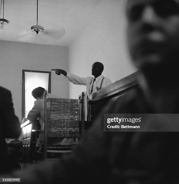 This dramatic courtroom scene shows 64-year-old "Uncle Mose" Wright, Grand-Uncle of murdered Emmett Till, 14-year-old Negro boy, as he stood up in...