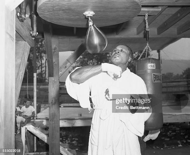 Tuning Up for the Big Fight. North Adams, Massachusetts: Light heavyweight champ Archie Moore, who says he's going to knock the heavyweight crown off...