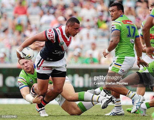 Sio Siua Taukeiaho of the Roosters is tackled during the round two NRL match between the Canberra Raiders and the Sydney Roosters at GIO Stadium on...