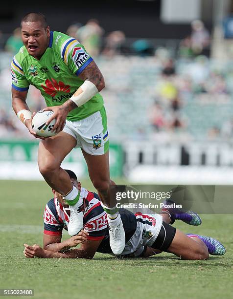 Joseph Leilua of the Raiders gets past a Roosters defender during the round two NRL match between the Canberra Raiders and the Sydney Roosters at GIO...