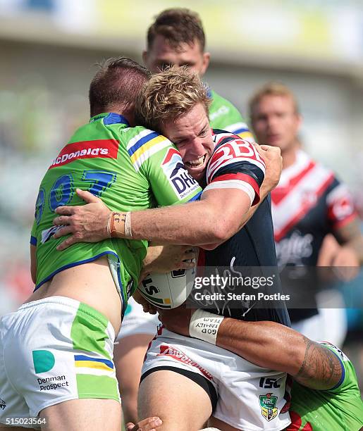 Mitchell Aubusson of the Roosters is tackled during the round two NRL match between the Canberra Raiders and the Sydney Roosters at GIO Stadium on...