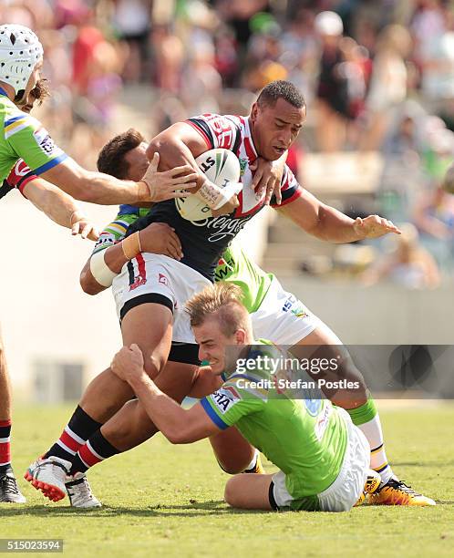 Sio Siua Taukeiaho of the Roosters is tackled during the round two NRL match between the Canberra Raiders and the Sydney Roosters at GIO Stadium on...