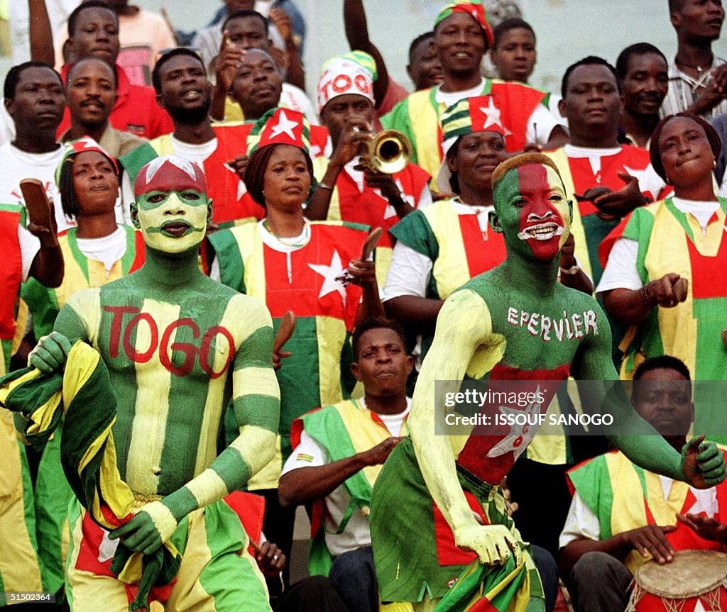 Painted supporters of Togo's national team sing an