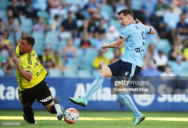 Shane Smeltz of Sydney FC takes a shot on goal as Ben Sigmund of Wellington Phoenix defends during the round 23 A-League match between Sydney FC and...