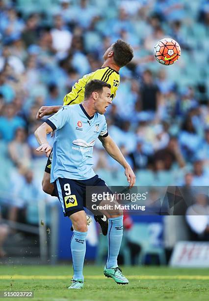 Shane Smeltz of Sydney FC and Ben Sigmund of Wellington Phoenix compete for the ball during the round 23 A-League match between Sydney FC and the...