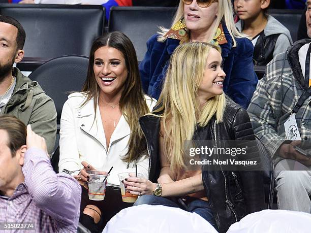 Lea Michele and Becca Tobin attend a basketball game between the New York Knicks and the Los Angeles Clippers at Staples Center on March 11, 2016 in...
