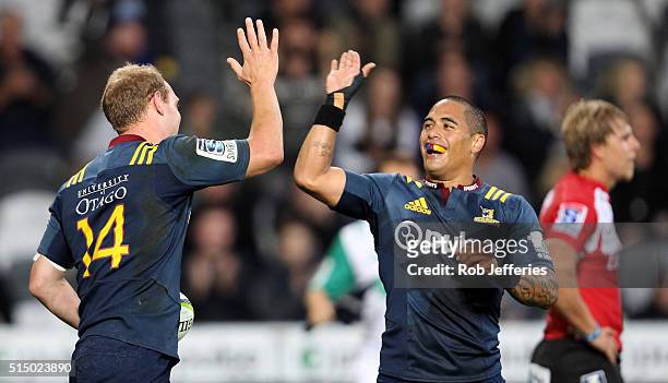 Matt Faddes of the Highlanders celebrates his try with Aaron Smith during the round three Super Rugby match between the Highlanders and the Lions at...