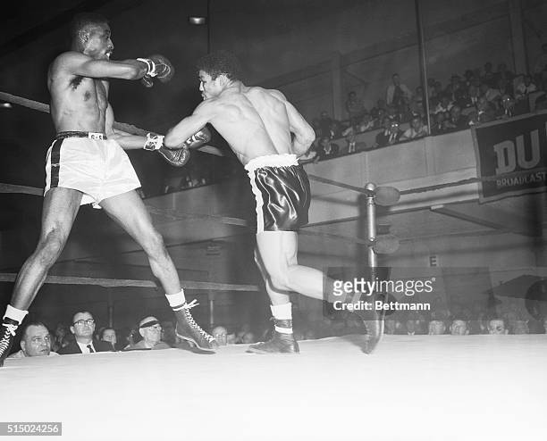 Undefeated middleweight fighter Rory Calhoun swings through the blow that downs Randy Sandy for the third time in their bout at St. Nicholas Arena....