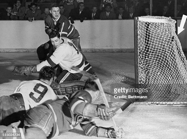 Jean Beliveau, of the Montreal Canadiens, blasts one past Detroit goalie Glenn Hall in second period of night game which saw the Habs take the...