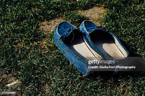 blue mocassins on the grass - suede shoe stock-fotos und bilder