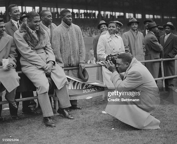 Willie Mays, star outfielder for the New York Giants was playing the role of photographer today at the Polo Grounds when he lined up pitcher Don...