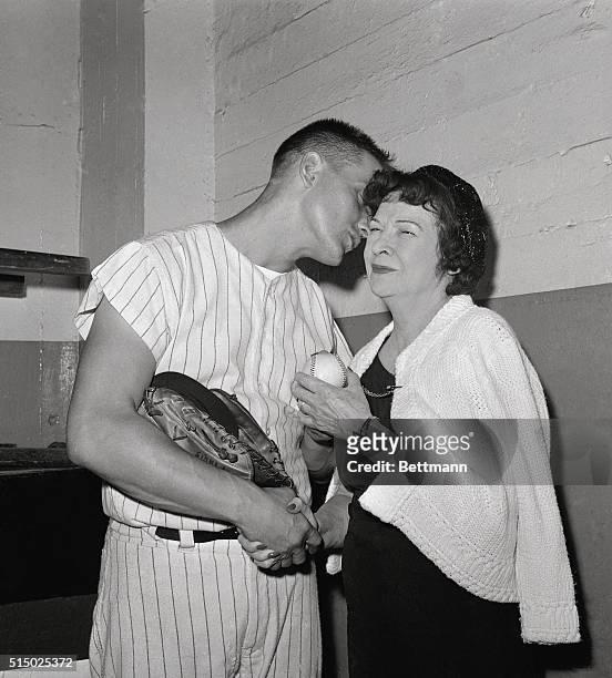 New York Yankee outfielder Roger Maris plants a kiss on the cheek of Mrs. Claire Babe Ruth, who was one of the first to congratulate the Yankee...