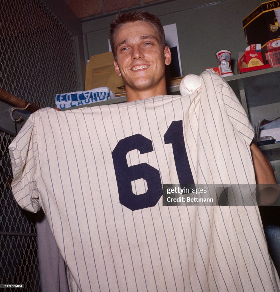 Roger Maris Displaying Baseball and Jersey