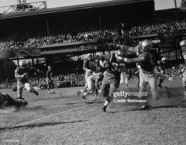 Washington Redskins Leo Elter, LH, about to be brought down by Detroit Lions Christiansen, As he came around right end for six yards. 1st period...