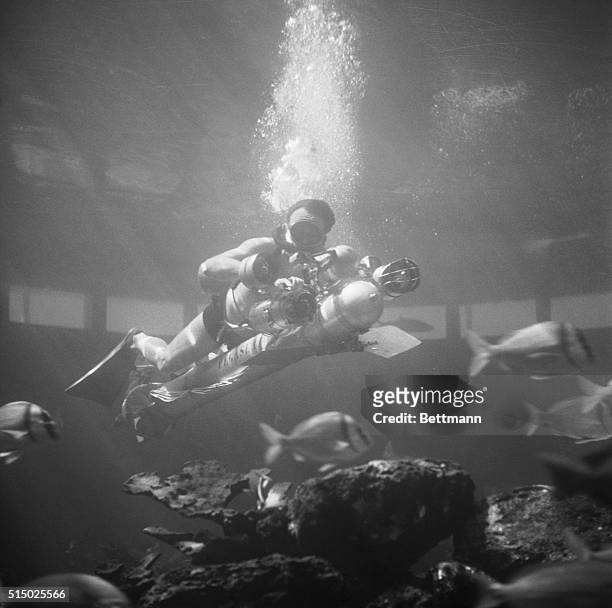 French inventor Dimitri Rebikoff demonstrates his Pegasus underwater vehicle at the Miami Seaquarium. The Pegasus is propelled through the water by...