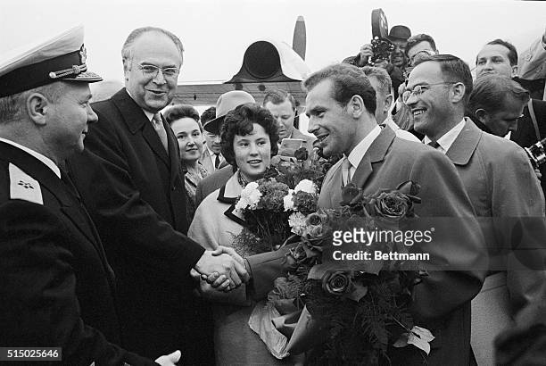 Soviet cosmonaut Gherman Titov and his wife, Tamara, are welcomed to Washington by Soviet ambassador Antoly Dobrynin after his arrival at National...