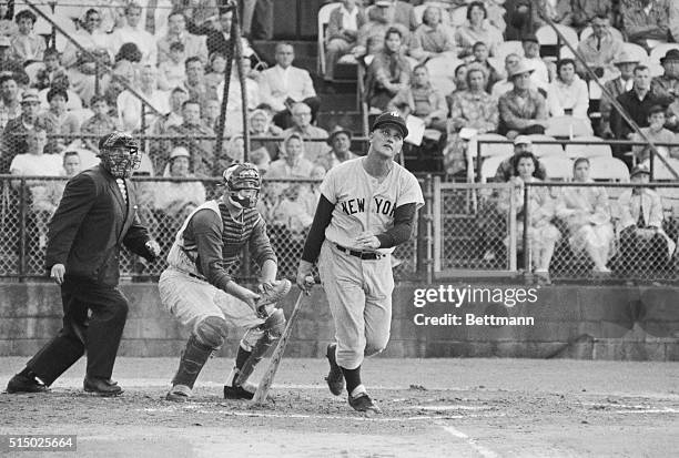 Roger Maris of the New York Yankees watches his first homer of spring training exhibition games go over the right field fence in first inning of game...