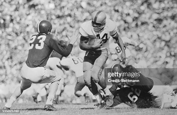 Action in the Cotton Bowl game between Texas Christian University and Syracuse shows Syracuse's All-American Jim Brown cracking TCU's right tackle...