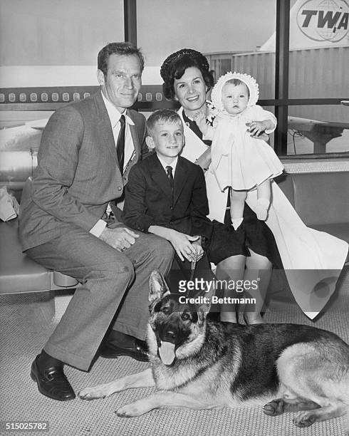 New York, NY- Charlton Heston arrives at New York's Idlewild Airport with his wife, Lydia and two children, Fraser and Holly . Heston is en route to...