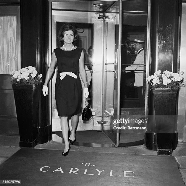 Mrs. Jacqueline Kennedy, wearing a becoming bow-at-the-waist number, leaves the Hotel Carlyle here June 8th for the hospital to visit her...