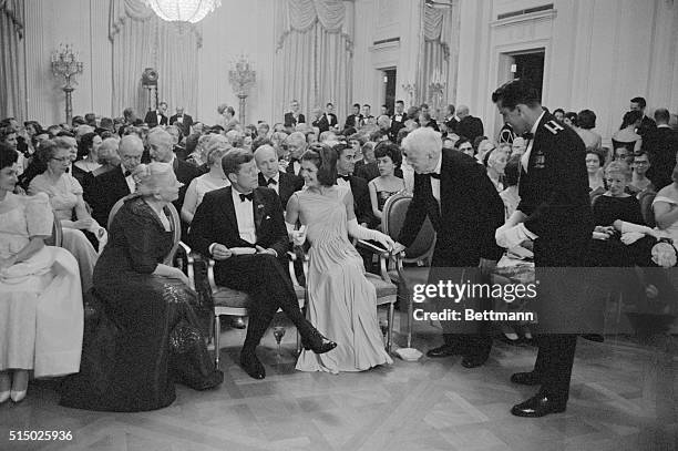 Washington, DC: Robert Frost and Mrs. Richard J. Walsh exchange greetings after a dinner given by President and Mrs. Kennedy at the White House,...