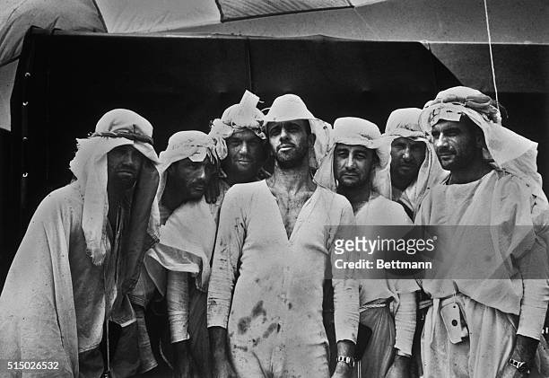 Believe it or not, these seedy looking "Arabs" actually represent the cream of American manhood. They are the seven Mercury Astronauts, gathered for...