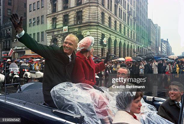 Washington: Spirits Undampened. Spirits undampened by a steady downpour, Col. John Glenn waves to the crowd on his way to speak to a joint session of...