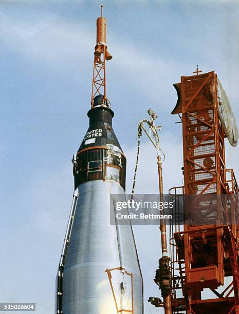 Aurora 7 rests on shoulders of Mercury-Atlas as final preparations are made for launching second U.S. Orbital astronaut Malcolm Scott Carpenter.