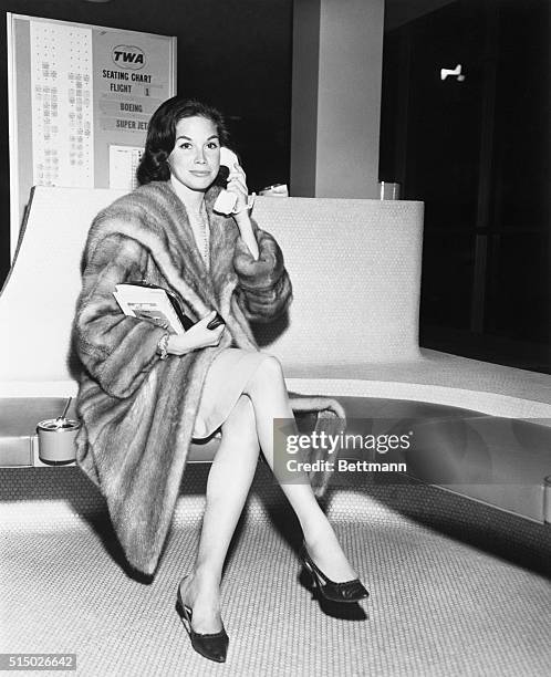 Television actress, Mary Tyler Moore, co-star of "The Dick Van Dyke Show" makes a last minute phone call before boarding a TWA SuperJet for Los...