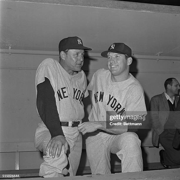 New York Yankee star Mickey Mantle, joins Yankee Manager Ralph Houk on the dugout steps before the first game in the series with the Los Angeles...