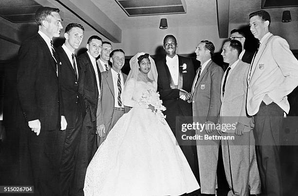 Big Bill Russell, one of the stars of the U.S. Basketball team that won the gold medal in the Olympics at Melbourne, is shown with his bride, the...