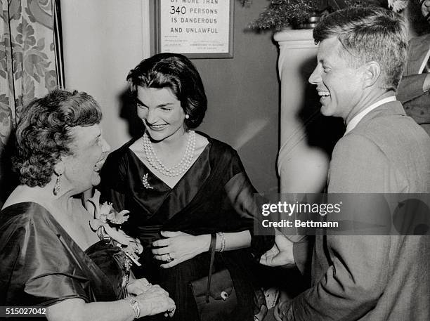 Senator and Mrs. John Kennedy are greeted by "The Hostess with the Mostest" Perle Mesta.