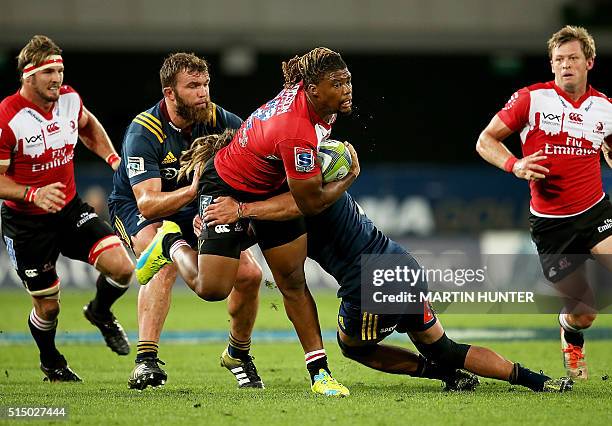 Howard Mnisi of the Lions is tackled by Dan Pryor of the Highlanders during the Super Rugby match between the Golden Lions from South Africa and...