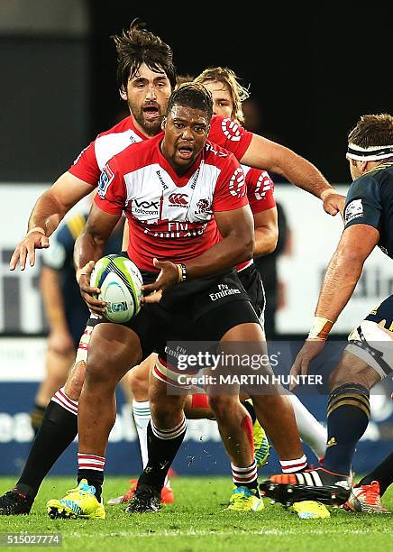 Howard Mnisi of the Lions is tackled by Luke Whitlock the Highlanders during the Super Rugby match between the Golden Lions from South Africa and...