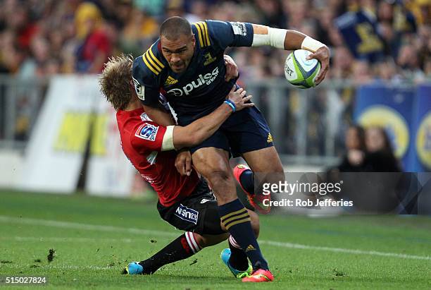Patrick Osborne of the Highlanders looks to bust the Lions defence during the round three Super Rugby match between the Highlanders and the Lions at...