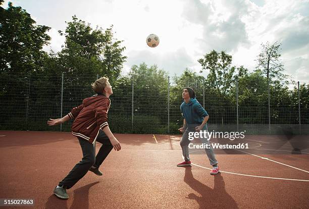 two boys playing soccer - jugador futbol fotografías e imágenes de stock