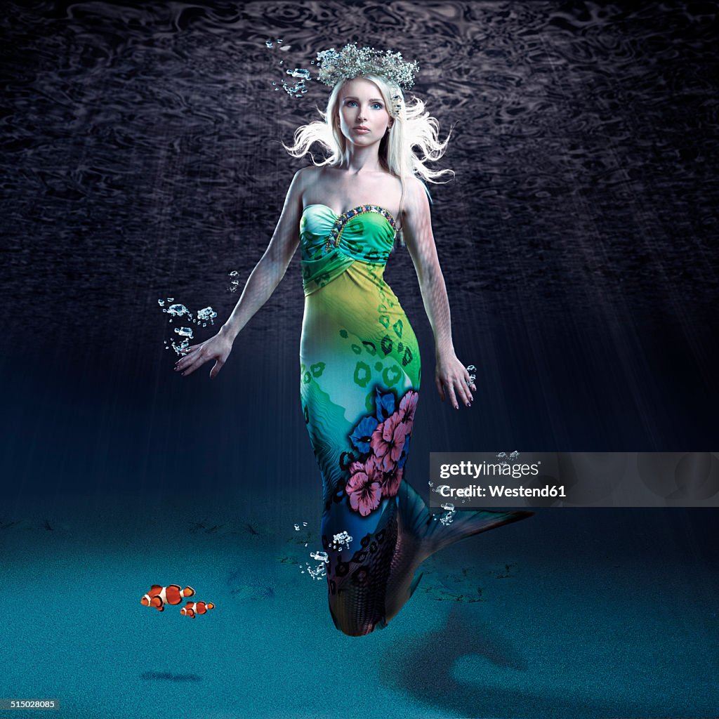 Young woman as mermaid under water