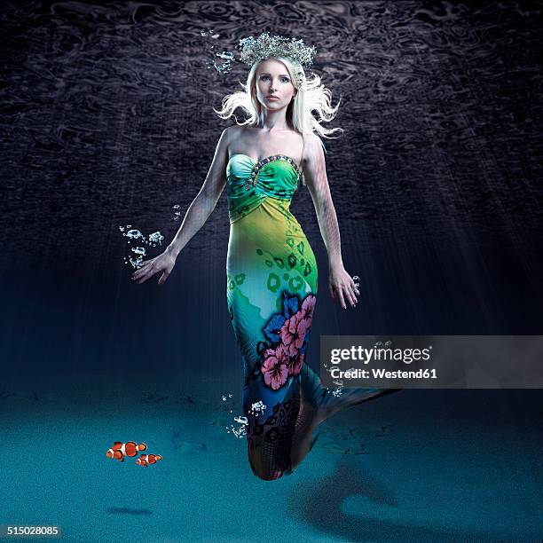 young woman as mermaid under water - fantasy mermaid stock pictures, royalty-free photos & images