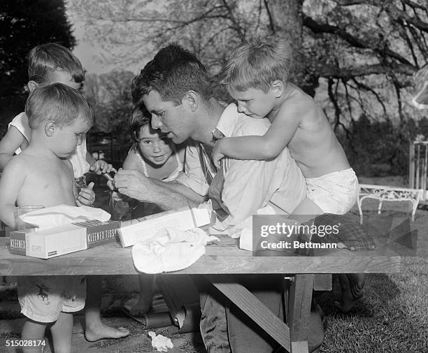 Robert Kennedy Jr, in front of unidentified child. Behind Robert Jr., Jar partly blocked by RFK; Robert Kennedy, Sr., and Joe with arms around RFK.