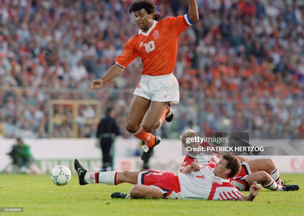 Dutch forward Ruud Gullit jumps over the attempted