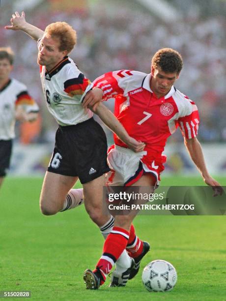 German midfielder Mathias Sammer is tackled by Danish midfielder John Jensen during the European Nations soccer championship final, 26 June 1992 in...