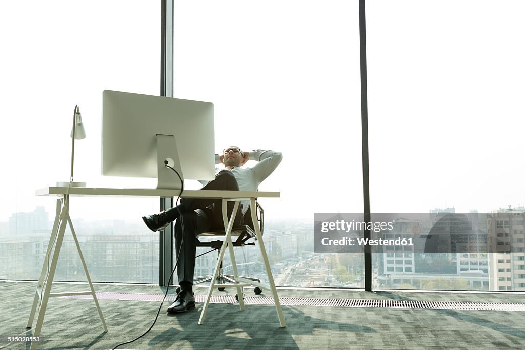 Businessman leaning back in new office