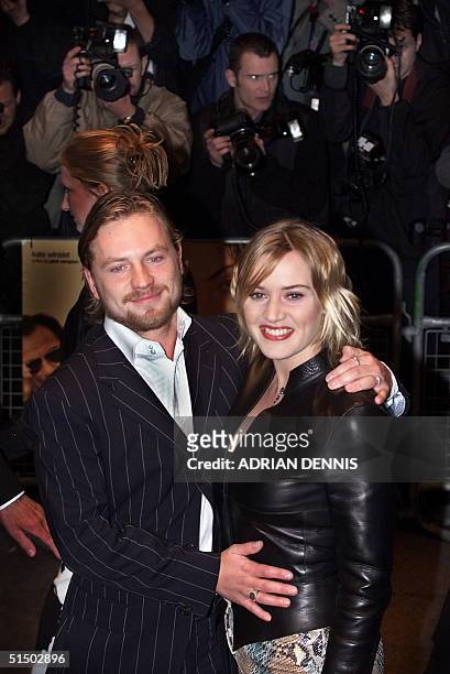 Kate Winslet poses for photographers with her husband film director Jim Threapleton at the premiere of "Holy Smoke" at the Odeon West End in London...