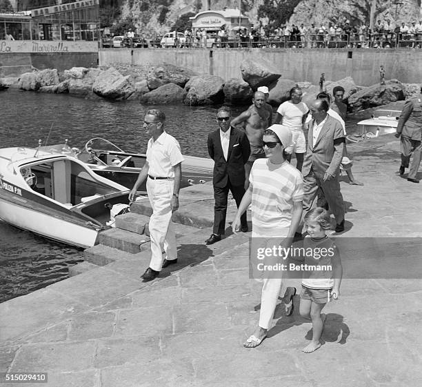 Barefoot Caroline and her mother Mrs. Jacqueline Kennedy stroll along a pier in Amalfi here, to board the yacht of Italian industrialist Gianni...