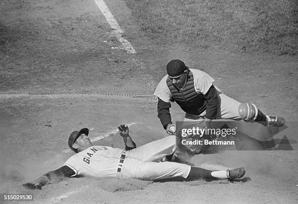 San Francisco Giants' third baseman Jim Davenport is out at home, as New York Yankees catcher Yogi Berra waits for him, ball in hand, in 7th inning...