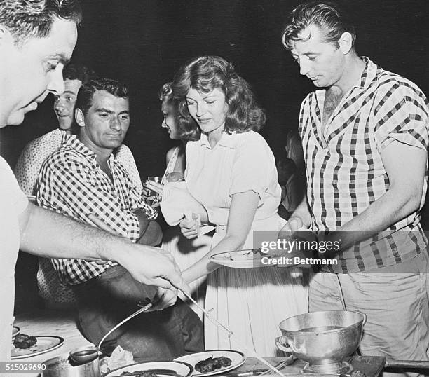 Among the other things Rita Hayworth got to do with her customary enthusiasm-is enjoy the Trinidad-style barbecue.